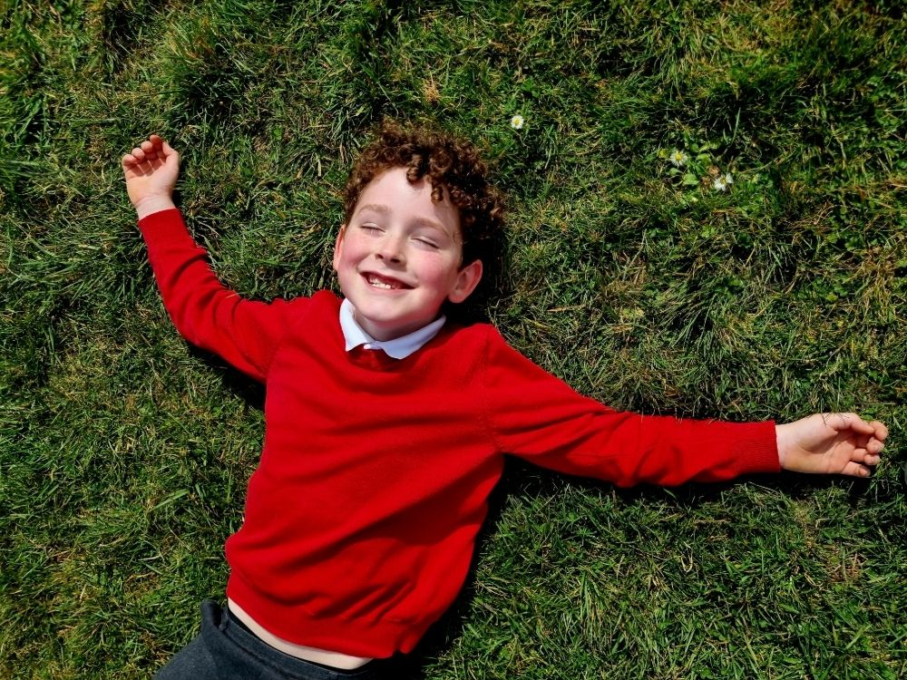 Braddock Primary Pupil on the grass