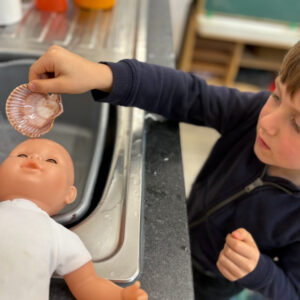 St Dominic Primary Pupil baptising doll